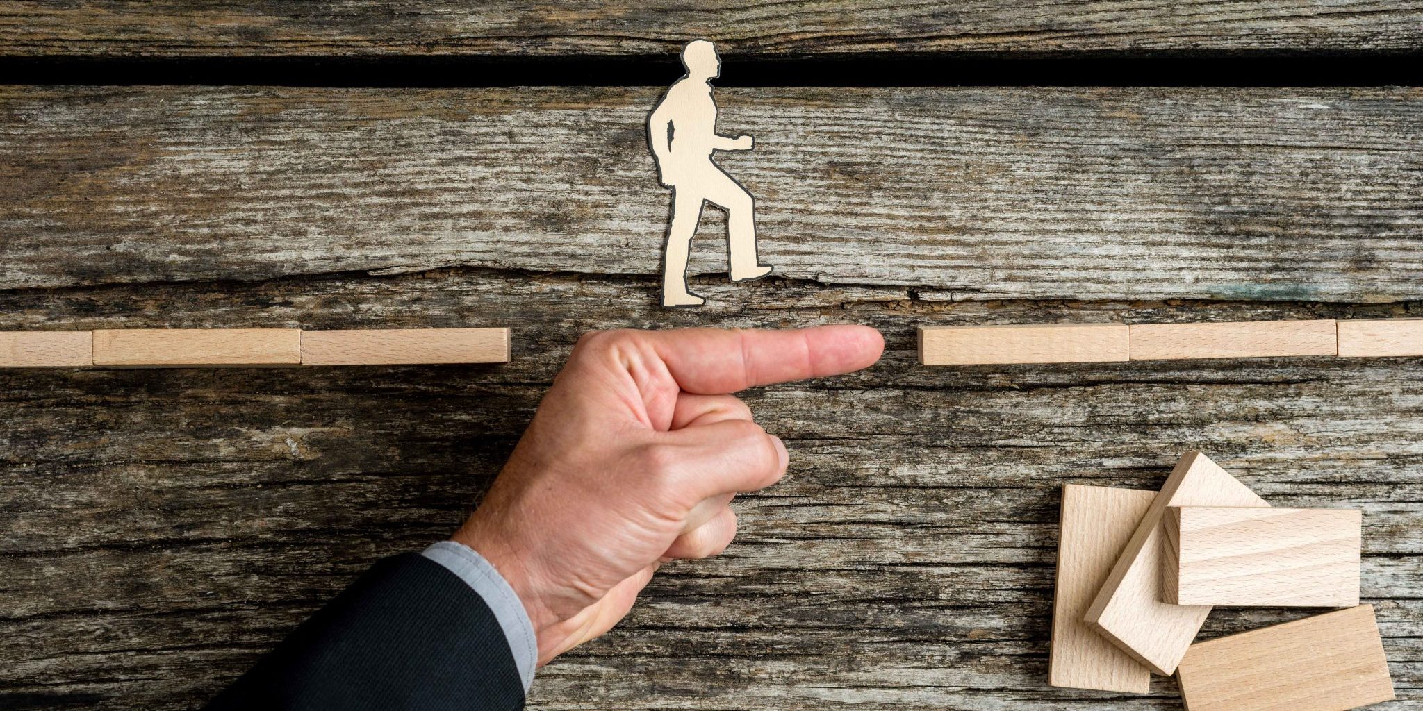 businessman-supporting-paper-cut-out-of-a-man-walk-2021-08-26-22-28-02-utc