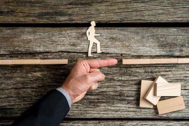 businessman-supporting-paper-cut-out-of-a-man-walk-2021-08-26-22-28-02-utc