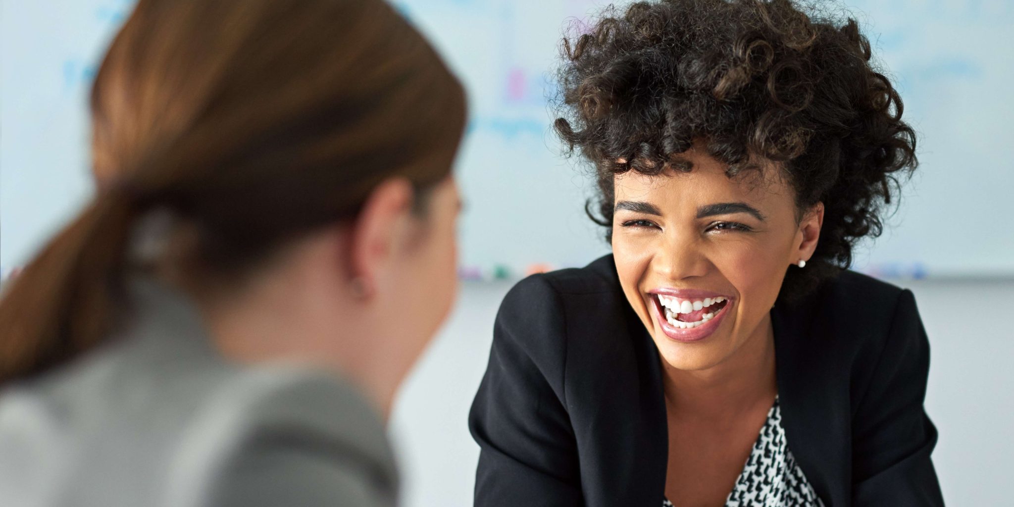 shot-of-two-businesswomen-enjoying-a-meeting-toget-2026-01-09-09-26-30-utc consultative selling vs persuasion