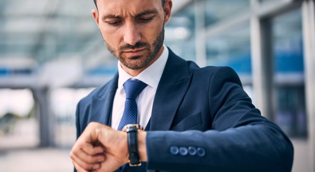 serious-man-checking-the-time-on-his-watch-2026-01-05-22-52-30-utc deadline motivation in sales reps